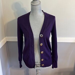 Purple cardigan with silver buttons.